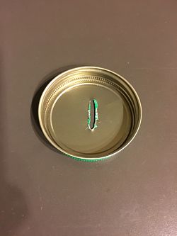 Photo of inside of Jar Lid with hammered-down sharp edges
